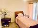 Cozy bedroom with a queen size bed, hardwood floors, and a sliding glass door at 3856 Commanche Ave, Las Vegas, NV 89121