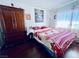 Bedroom features a large wooden dresser, floral decor, and hardwood floors at 3856 Commanche Ave, Las Vegas, NV 89121