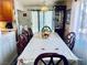 Dining room with a long table with seating for eight, with a decorative china cabinet at 3856 Commanche Ave, Las Vegas, NV 89121