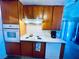 Galley kitchen equipped with a white tile backsplash, cooktop, and wall oven at 3856 Commanche Ave, Las Vegas, NV 89121