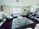 Living room view with hardwood floors, vintage furniture, large area rug, and bright natural light at 3856 Commanche Ave, Las Vegas, NV 89121