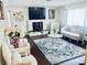 Bright living room features a charming fireplace, hardwood floors, and traditional-style decor at 3856 Commanche Ave, Las Vegas, NV 89121