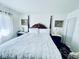 Bright and airy bedroom with a king bed, decorative wall art, and white walls at 3856 Commanche Ave, Las Vegas, NV 89121