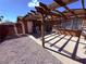 Back patio area featuring gravel, concrete and a wood pergola at 3856 Commanche Ave, Las Vegas, NV 89121