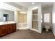 Bathroom featuring marble floors, jacuzzi tub, glass shower and single vanity at 42 Gulf Stream Ct, Las Vegas, NV 89113