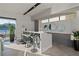 Contemporary bar area featuring modern stools, stylish decor, and access to an outdoor patio with water views at 42 Lakefront Dr, Henderson, NV 89011