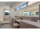 Spa-like bathroom with double sinks, a large mirror, sleek vanities, and a spacious walk-in shower with luxurious finishes at 42 Lakefront Dr, Henderson, NV 89011