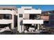 Modern home showcases a sleek design, private patio with outdoor seating and pool views at 42 Lakefront Dr, Henderson, NV 89011