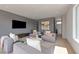 Relaxing living room with a large TV, comfortable seating, and elegant decor, perfect for entertainment at 42 Lakefront Dr, Henderson, NV 89011