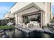 Inviting outdoor patio with comfortable seating, a serene water feature, and seamless indoor-outdoor living at 42 Lakefront Dr, Henderson, NV 89011