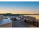 Modern rooftop deck featuring stylish seating, an outdoor kitchen, and scenic lake views at 42 Lakefront Dr, Henderson, NV 89011