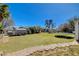 Large backyard with green grass, a storage shed, and mature trees at 425 Bonelli Ave, Overton, NV 89040