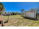 View of the backyard featuring a storage shed, mature trees, and grassy areas at 425 Bonelli Ave, Overton, NV 89040