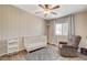 Bedroom featuring a ceiling fan, a crib and a comfortable chair perfect for a baby room at 425 Bonelli Ave, Overton, NV 89040