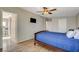 Comfortable bedroom featuring wood-look floors, ceiling fan, and a modern wall-mounted television at 425 Bonelli Ave, Overton, NV 89040