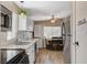 This home includes a kitchen with stainless steel appliances, white cabinets, and wood look flooring at 425 Bonelli Ave, Overton, NV 89040