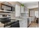 Bright kitchen features white cabinets, stainless steel appliances, and wood look flooring at 425 Bonelli Ave, Overton, NV 89040