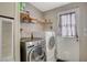 Laundry room featuring modern washer and dryer, shelving for storage, and convenient access door at 425 Bonelli Ave, Overton, NV 89040