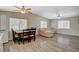 Open-concept living room features wood floors, natural light, a dining table, and a comfortable couch at 425 Bonelli Ave, Overton, NV 89040