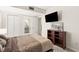 Neutral bedroom featuring a television, wood-style floors, and open bathroom door at 4575 Dean Martin Dr # 1103, Las Vegas, NV 89103
