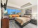 A primary bedroom boasts floor to ceiling windows with city views, a TV, and stylish furnishings at 4575 Dean Martin Dr # 1103, Las Vegas, NV 89103
