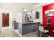 Modern kitchen boasts stainless steel appliances, gray cabinets, granite countertops, and a bold red accent wall at 4575 Dean Martin Dr # 1103, Las Vegas, NV 89103