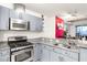 Granite countertops and stainless steel appliances featured in this modern kitchen with light gray cabinets at 4575 Dean Martin Dr # 1103, Las Vegas, NV 89103