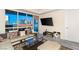 Living room with floor-to-ceiling windows showcasing a beautiful city view and a mounted flat screen television at 4575 Dean Martin Dr # 1103, Las Vegas, NV 89103