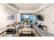 Bright living room featuring floor-to-ceiling windows with city views, contemporary furnishings, and a sleek TV at 4575 Dean Martin Dr # 1103, Las Vegas, NV 89103