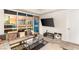Living room with floor-to-ceiling windows showcasing a beautiful city view and a mounted flat screen television at 4575 Dean Martin Dr # 1103, Las Vegas, NV 89103
