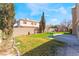 Spacious backyard featuring a lush green lawn, privacy fence, and play set, perfect for entertaining at 4708 Royal Sunset Ct, Las Vegas, NV 89130
