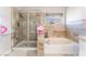 A bathroom with a shower and bath at 4708 Royal Sunset Ct, Las Vegas, NV 89130