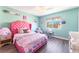 Bedroom featuring light green walls, wood floors, pink bed, and a view of outdoors through the window at 4708 Royal Sunset Ct, Las Vegas, NV 89130