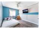 Bright bedroom featuring a blue accent wall, ceiling fan, and cozy furniture at 4708 Royal Sunset Ct, Las Vegas, NV 89130