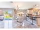 Charming breakfast nook with a glass table, chairs, and sliding glass doors leading to the backyard at 4708 Royal Sunset Ct, Las Vegas, NV 89130
