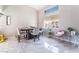 Bright dining area featuring stylish decor, a modern table, and a large window with natural light at 4708 Royal Sunset Ct, Las Vegas, NV 89130