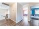 Upstairs hallway with wood floors and wrought iron railing leads to bedrooms with doors open to each, chandelier overhead at 4708 Royal Sunset Ct, Las Vegas, NV 89130
