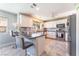 Modern kitchen with stainless steel appliances, granite countertops, and a breakfast bar with seating at 4708 Royal Sunset Ct, Las Vegas, NV 89130