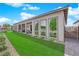 Beautiful backyard featuring lush landscaping, covered patio, and seamless indoor-outdoor flow at 5095 E Long Leaf Ct, Pahrump, NV 89061