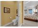 Well-lit bathroom with a neutral color scheme, toilet, and a view of a Primary bedroom at 5095 E Long Leaf Ct, Pahrump, NV 89061