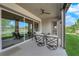 Stylish covered patio with ceiling fan, outdoor seating and views of the green backyard at 5095 E Long Leaf Ct, Pahrump, NV 89061