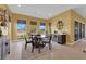 Inviting dining area featuring a modern table set, beverage cooler, and scenic outdoor views at 5095 E Long Leaf Ct, Pahrump, NV 89061