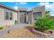 A home featuring a landscaped entrance with a custom front door, pavers and potted plants at 5095 E Long Leaf Ct, Pahrump, NV 89061