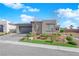 Single-story home featuring desert landscaping, paved driveway and walkway and a two-car garage at 5095 E Long Leaf Ct, Pahrump, NV 89061