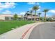 Community clubhouse featuring desert landscaping, grass lawn, and exterior building features at 5095 E Long Leaf Ct, Pahrump, NV 89061