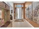 Inviting foyer with neutral tones, decorative sunflower artwork, and a sunlit front door at 5095 E Long Leaf Ct, Pahrump, NV 89061