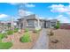 A desert landscape highlights this single-story home with a paved walkway to the front door at 5095 E Long Leaf Ct, Pahrump, NV 89061