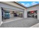 Garage with custom flooring, storage, and parking for multiple cars and a golf cart at 5095 E Long Leaf Ct, Pahrump, NV 89061