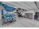 Garage featuring custom flooring, storage, and parking for a golf cart and motorcycle at 5095 E Long Leaf Ct, Pahrump, NV 89061