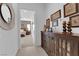 Hallway view of a tastefully decorated home with a glimpse into the tranquil main bedroom at 5095 E Long Leaf Ct, Pahrump, NV 89061